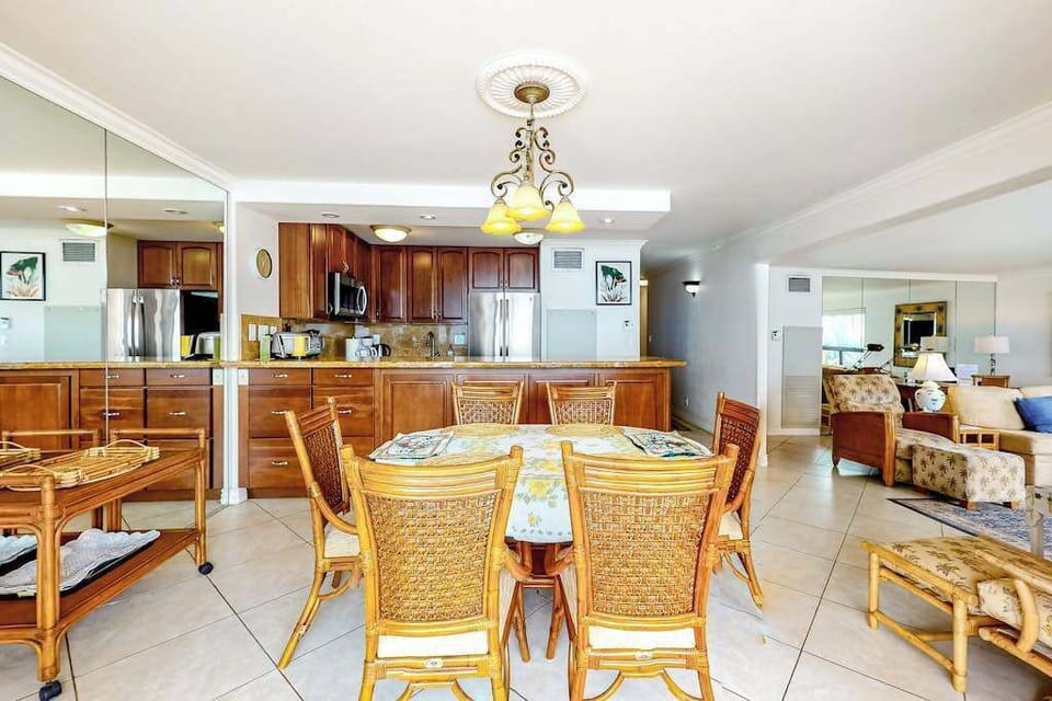 Dining room table with seating for six and open to the kitchen and you can feel the ocean breeze when you open the sliders to the lanai.