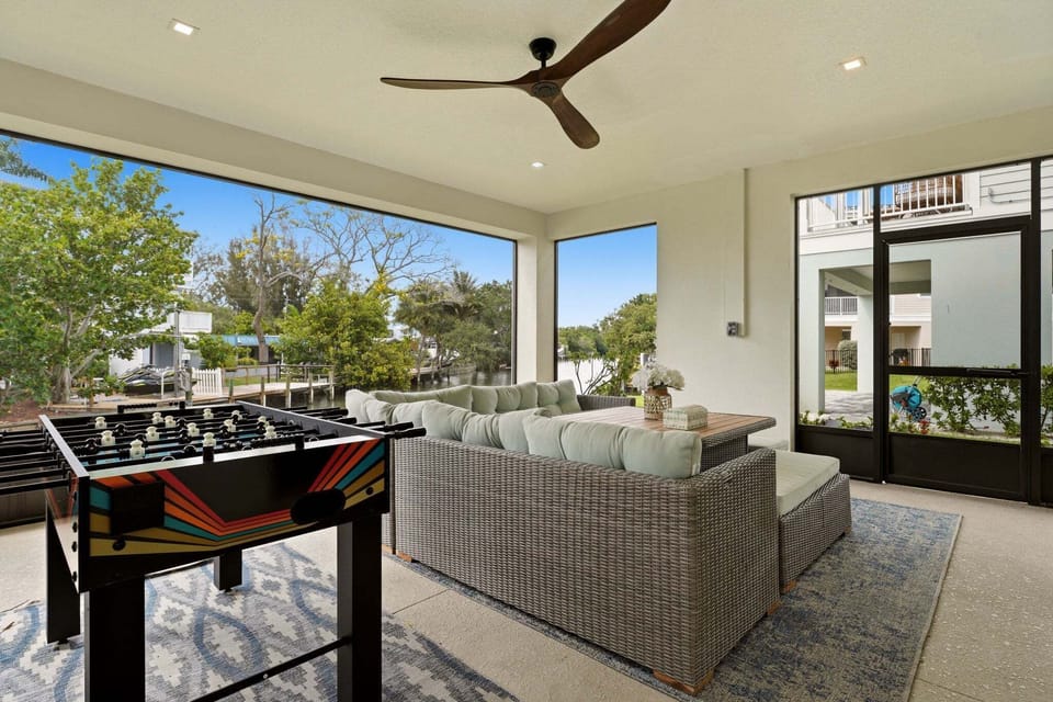 Another angle of the enclosed lounge showcases the generous sectional seating arrangement and wood-topped coffee table, perfect for relaxing after a day on the water.