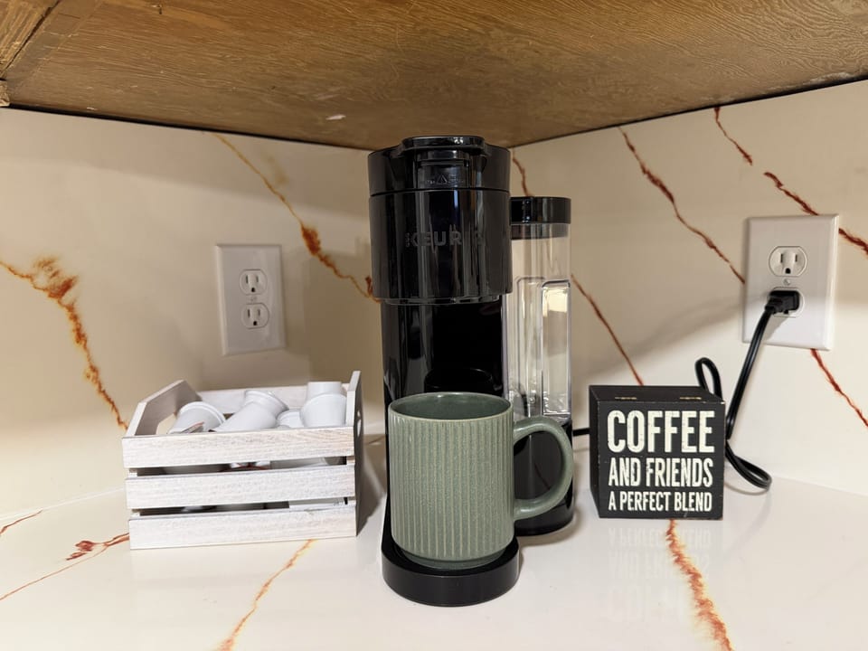 Convenient coffee station with pods, mug, and a clean modern setup