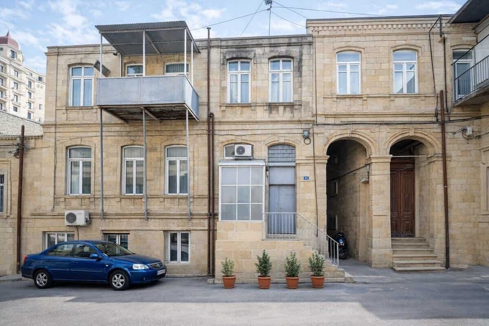 Historic exterior and courtyard approach to the apartment's private entrance.