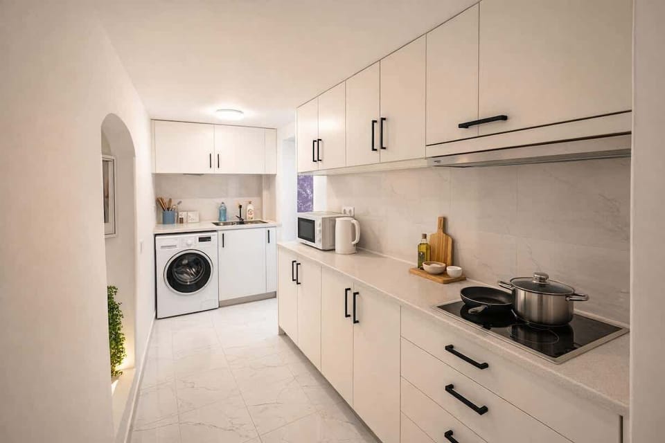Bright modern kitchen with washer, cooktop and ample storage—stay-in ready.