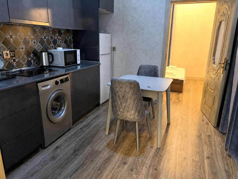 Kitchen and dining area with washing machine.