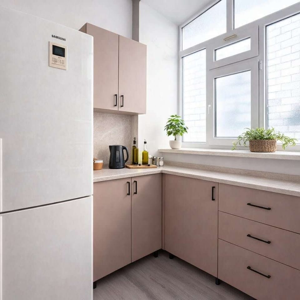 Bright L-shaped kitchen with sleek cabinets, big window, and essentials.