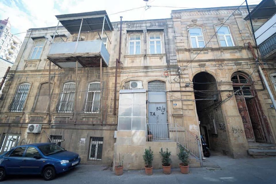 Historic stone façade and courtyard approach to the private entrance.