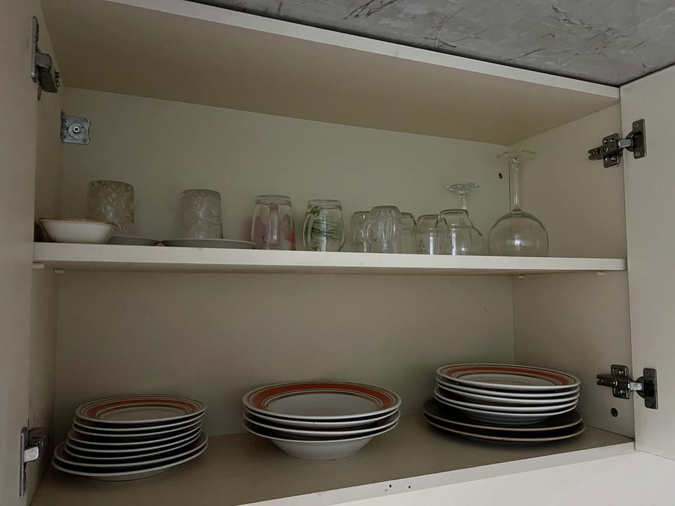 Plates, bowls, mugs, and glassware provided.