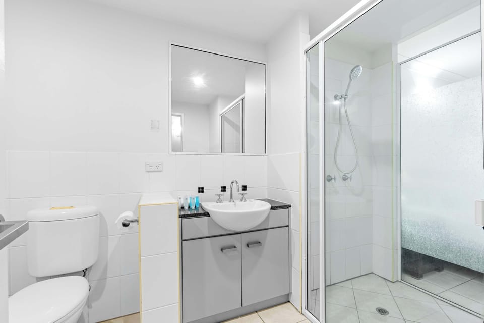 Refresh in the studio bathroom, where a walk-in shower, a generous vanity, and complimentary toiletries make it easy to unwind after exploring Trinity Beach.