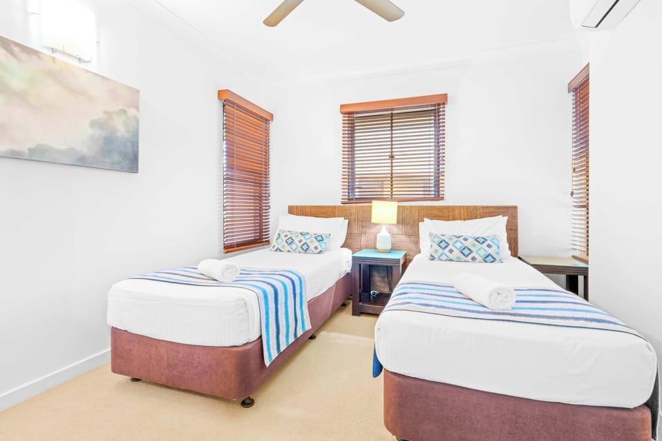 The second bedroom offers two single beds in a bright, comfortable setting that's well-suited to children or friends travelling together.