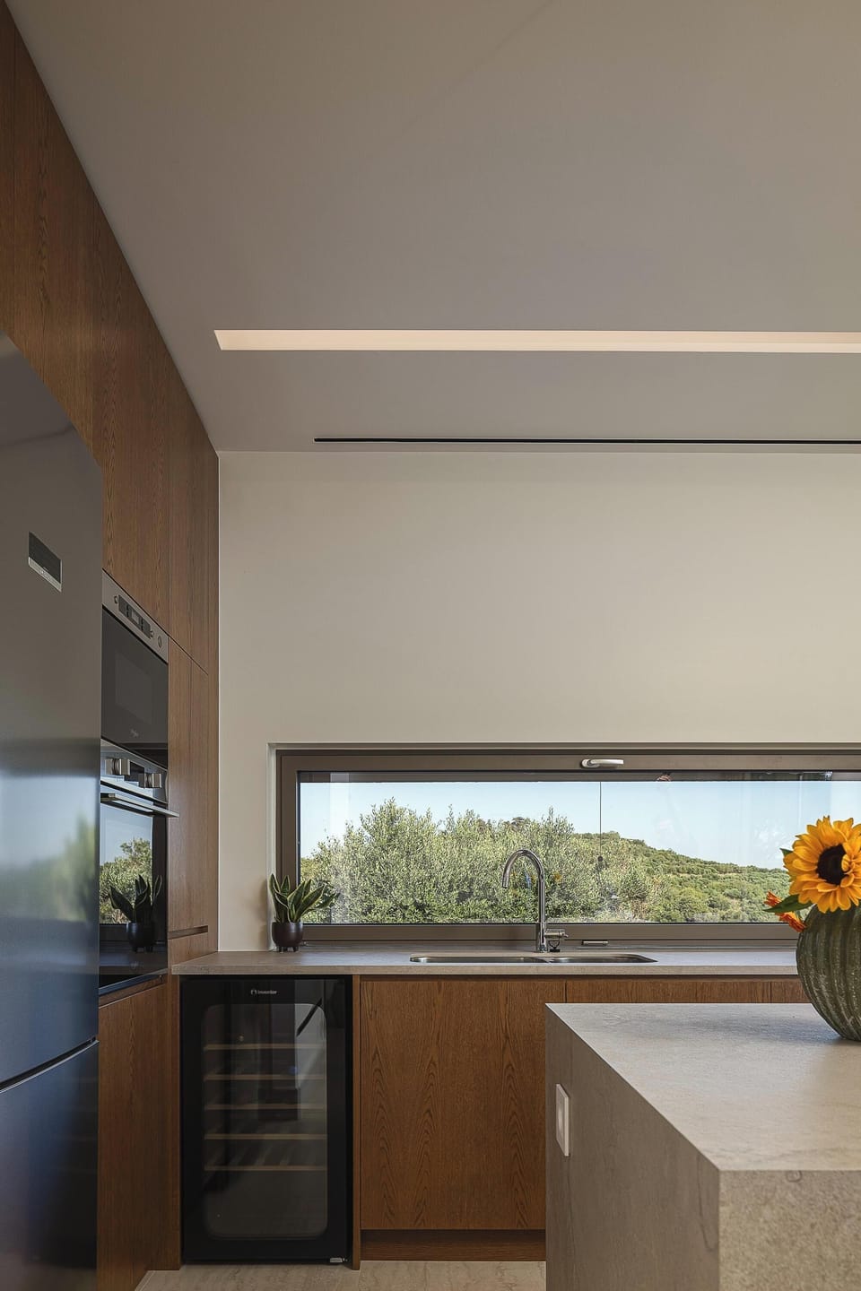 Contemporary kitchen featuring modern appliances and a functional layout, seamlessly connected with the open-plan living and dining areas.