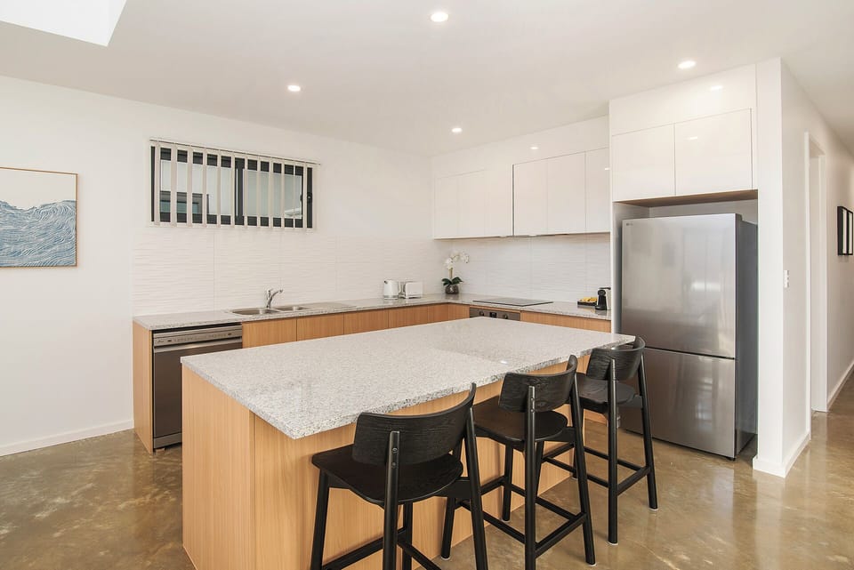 Bright modern kitchen with large island seating and sleek finishes
