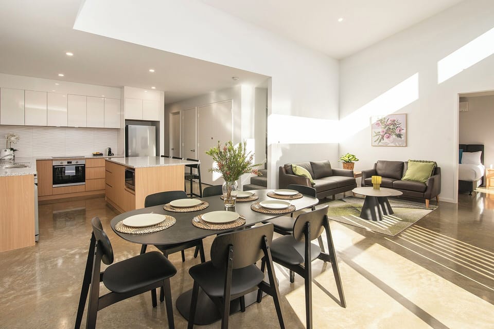 Sun-filled open-plan living with modern kitchen, dining, and lounge