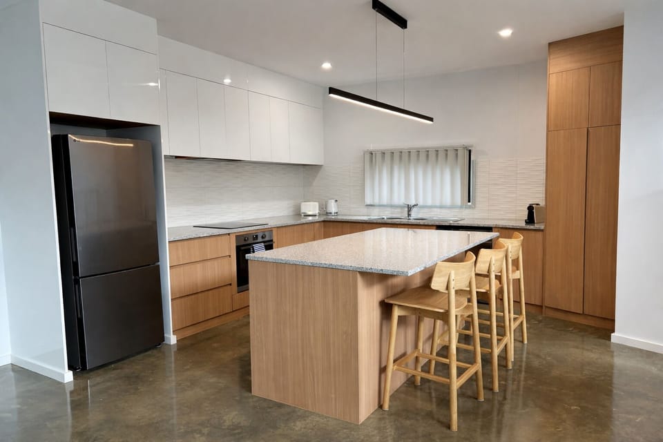 Sleek modern kitchen with island seating and stainless appliances