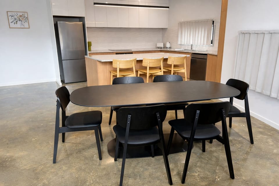 Sleek kitchen with island + 6-seat dining, stainless appliances