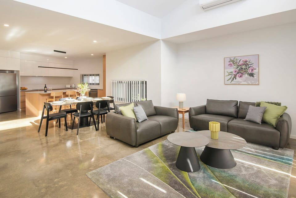 Bright open-plan living with stylish lounge, dining area, and modern kitchen
