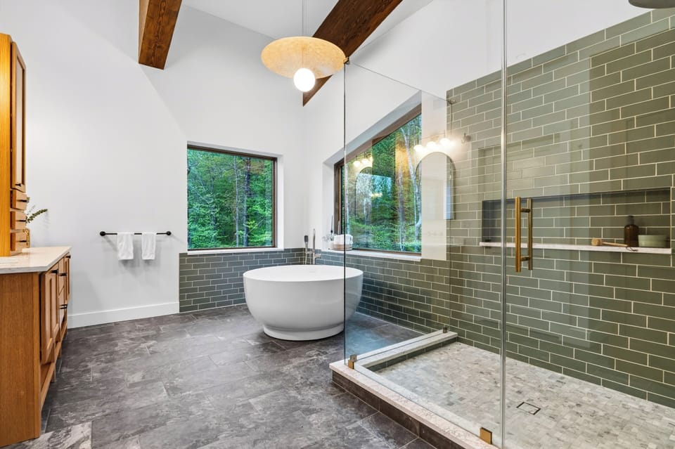 The primary bedroom's ensuite features a shower and a soaking tub.