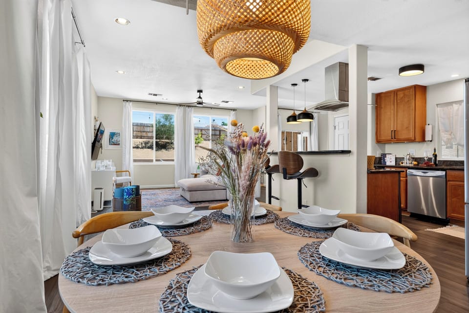 A beautifully staged dining space sits perfectly positioned between the kitchen and living areas for a cohesive flow.