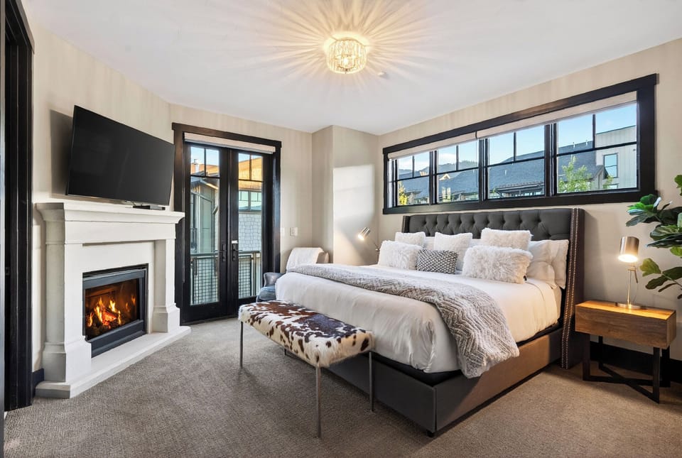 Spacious main bedroom layout with a private balcony entrance and a classic fireplace.