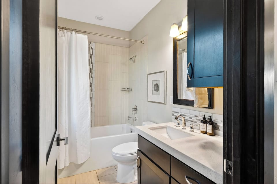 Clean secondary bathroom complete with a full shower-tub combination.