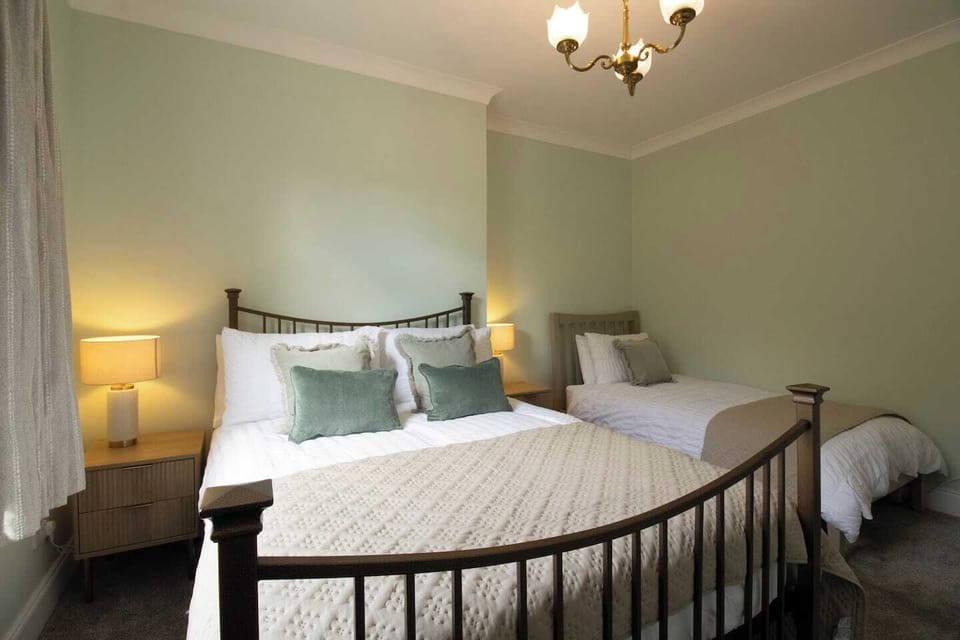 Sink into soft bedding and enjoy a restful night's sleep in this inviting bedroom. Designed for comfort and relaxation, it's your private retreat to recharge and feel at home throughout your stay.