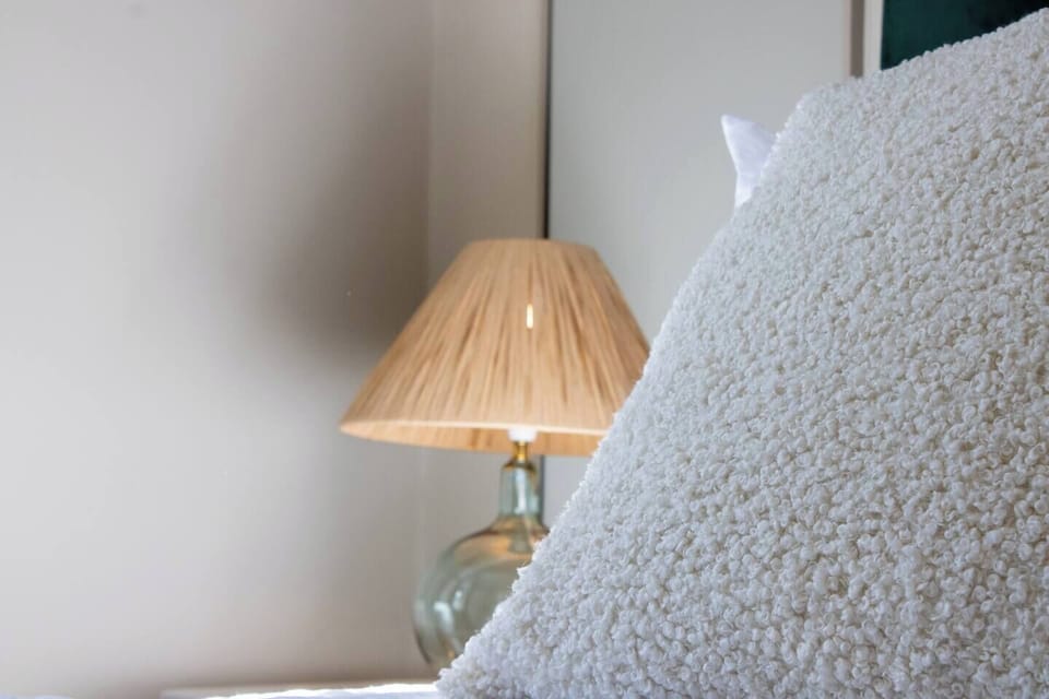 Comfortable single bed with fresh linen, soft pillows and simple, calming décor.
