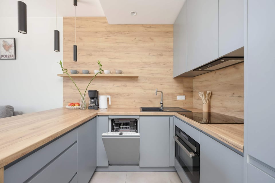 Fully equipped kitchen with modern appliances, ample storage and elegant wood finishes.