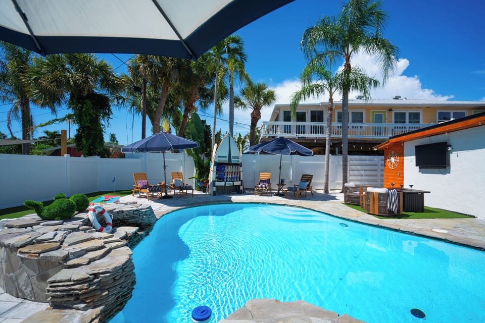 Your own private oasis in Indian Rocks Beach includes a freeform heated pool, custom waterfall and a shaded outdoor lounge waiting for you. 