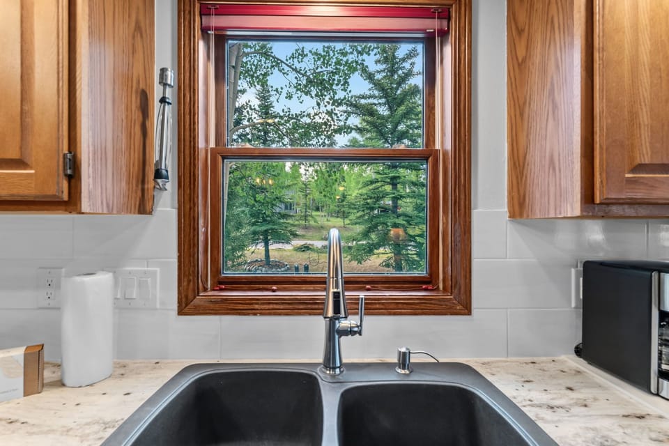 Prepare your favorite meals at this well-equipped kitchen sink with a lovely view of the wooded grounds outside your window.