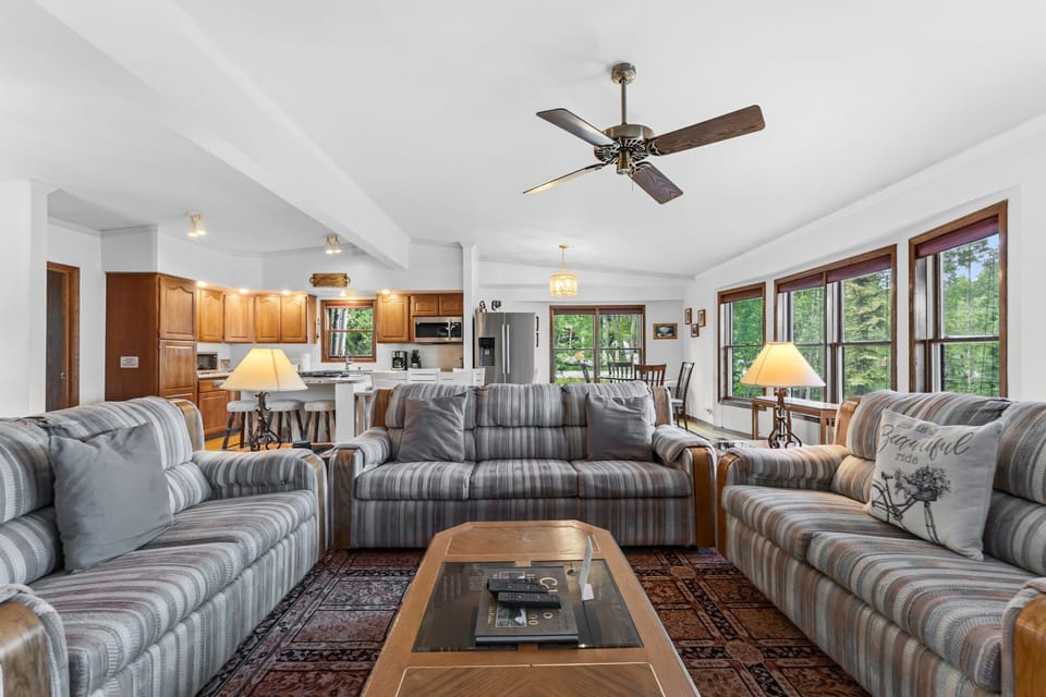 Sink into plush sofas and enjoy the seamless open-plan living space. Natural light floods through large windows while the ceiling fan keeps you comfortable year-round.