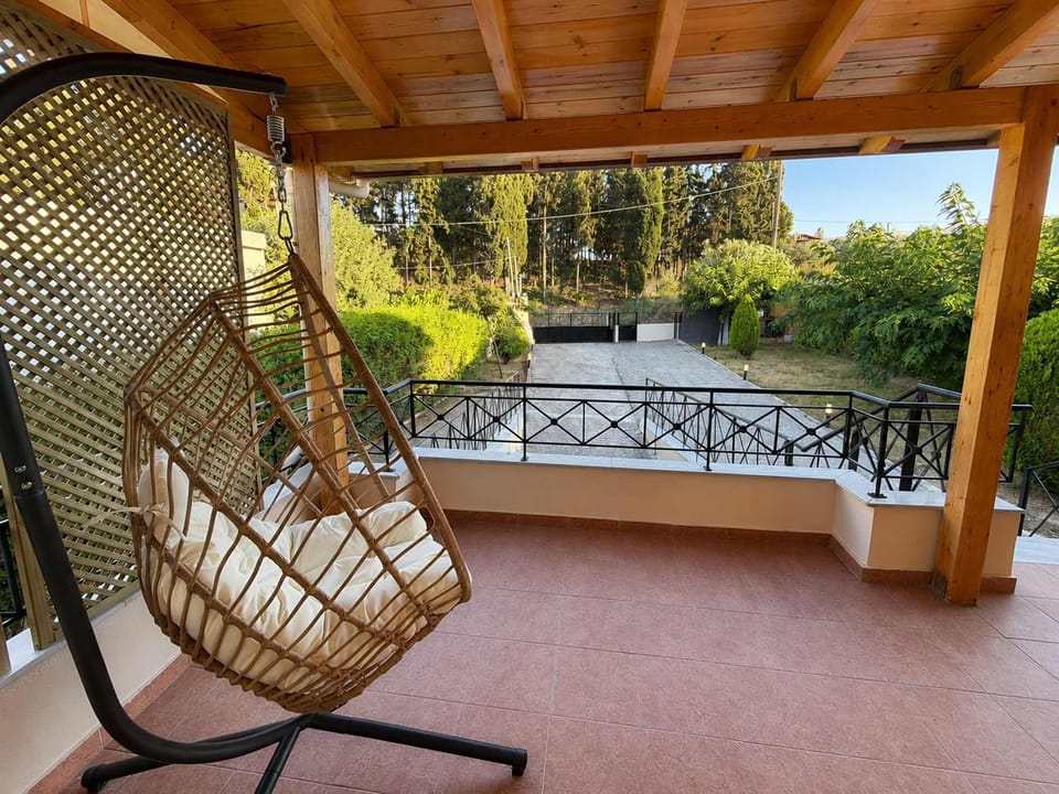 Rattan swing on shaded terrace