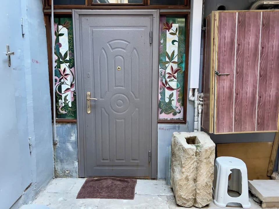 Apartment entry door with decorative stained-glass details.