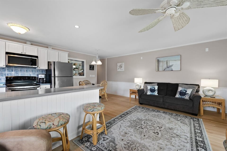 Pull up a stool at the kitchen counter or unwind on the comfortable sofa in this thoughtfully laid-out living space.
