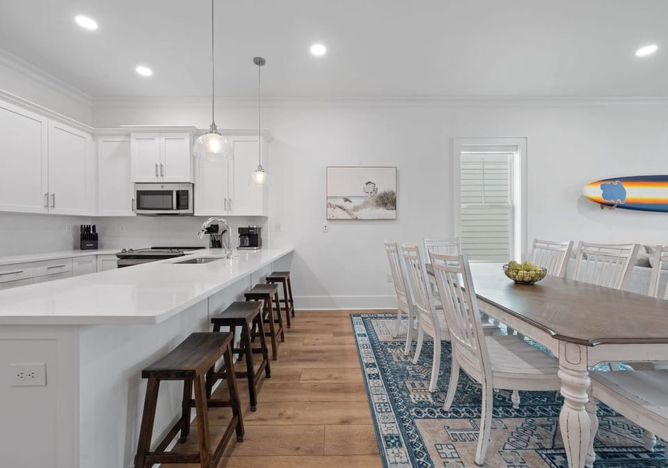 Large dining table with seating for the whole group plus additional bar seating.