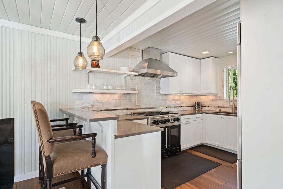 Warm wood floors and bar seating keep the cook in the heart of the conversation.
