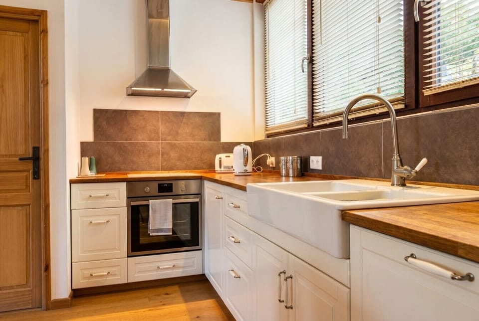 Cook up a feast in this bright kitchen with butcher block worktops and a deep sink.