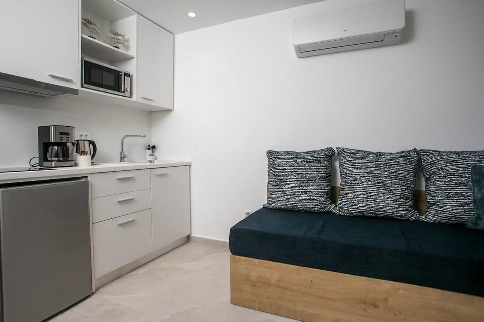 The kitchenette and sitting area in one open layout, designed for easy everyday use during short stays, work trips or longer visits in the heart of Rhodes.