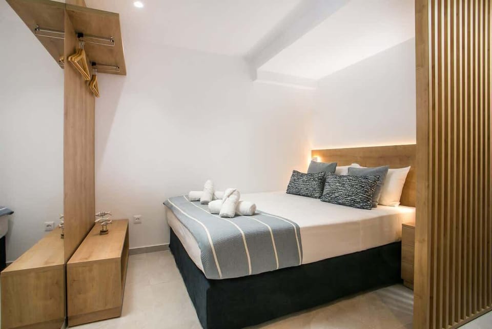 The queen sleeping area, with warm wood details, soft lighting and a restful arrangement for quiet evenings after beach time, harbour walks or Old Town exploring.