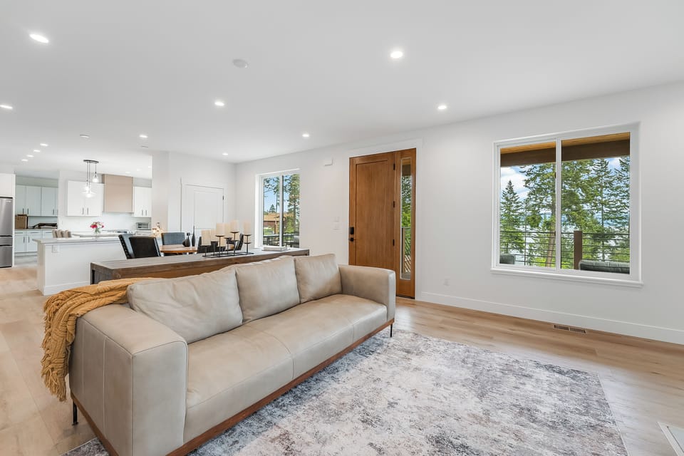 Relax in your bright, open living space with modern design and stunning lake views. Natural light fills the room through large windows, creating a warm and inviting atmosphere.