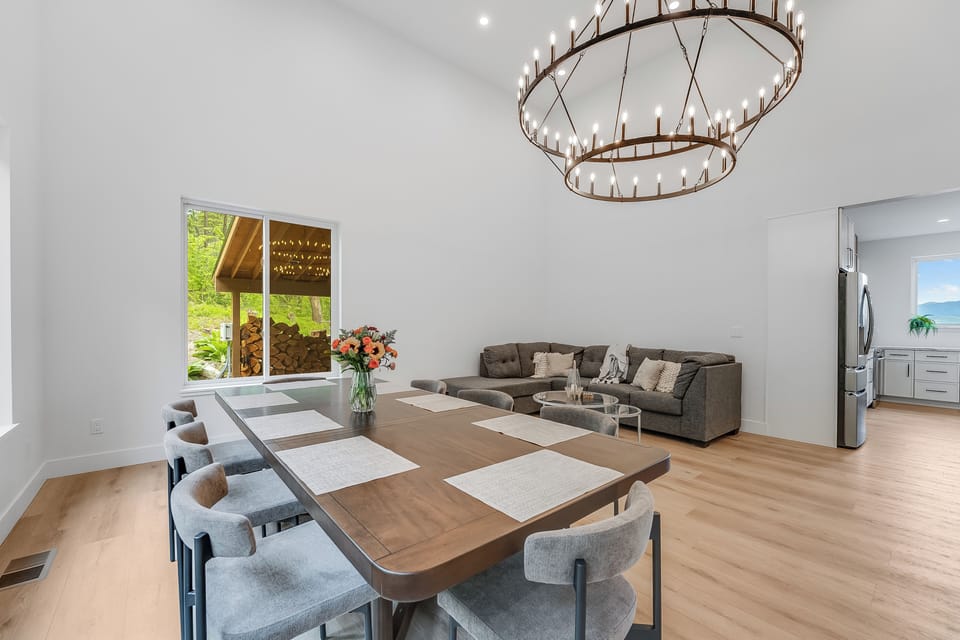 Gather around your spacious dining table under a stunning chandelier, with natural light streaming in and mountain views just beyond. The open layout connects seamlessly to your living area and kitchen.
