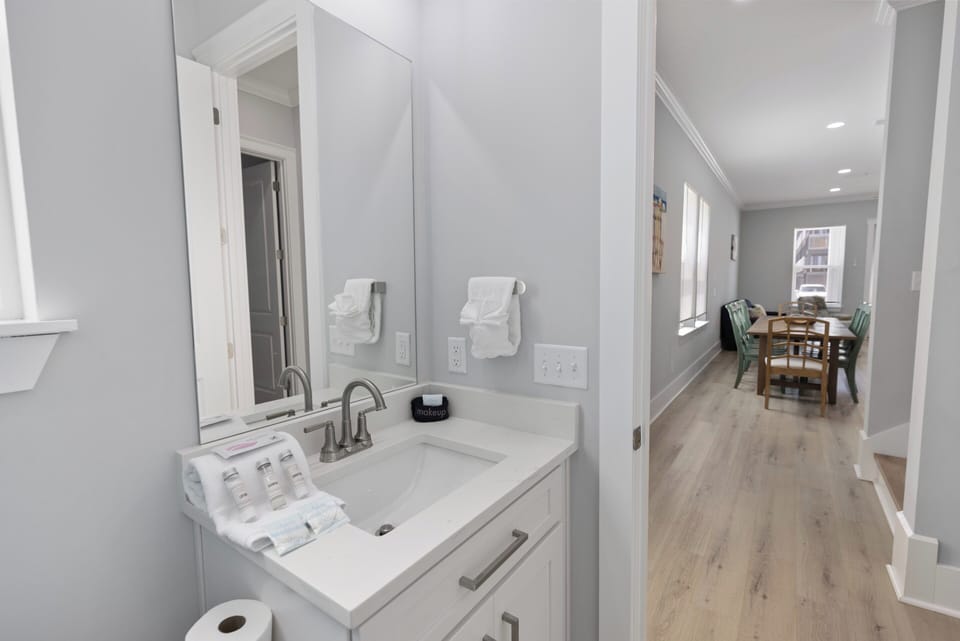 Bright bathroom with coastal color and soft towels.