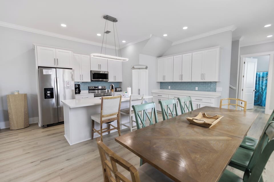 Modern coastal kitchen with stainless appliances and spacious dining.