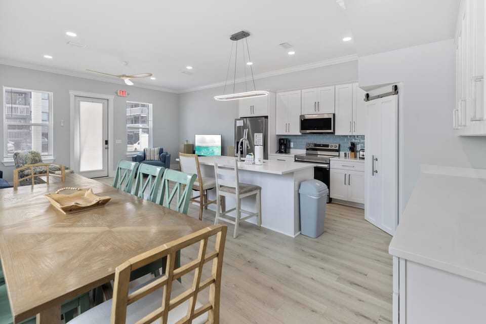 Modern coastal kitchen with stainless appliances and spacious dining.