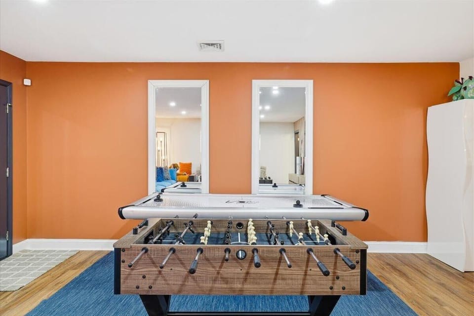 Pick your table — foosball on one side, air hockey on the other, and the mirrors make the whole room feel twice as big.