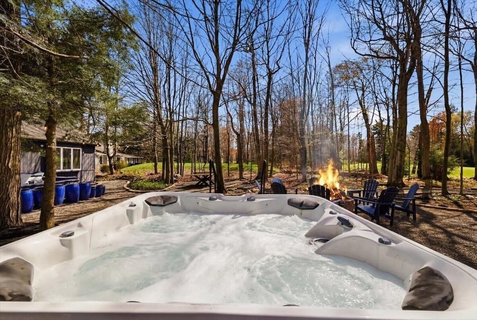Sink into the hot tub while the fire pit crackles a few steps away and the fairway disappears into the trees — your last stop every night.