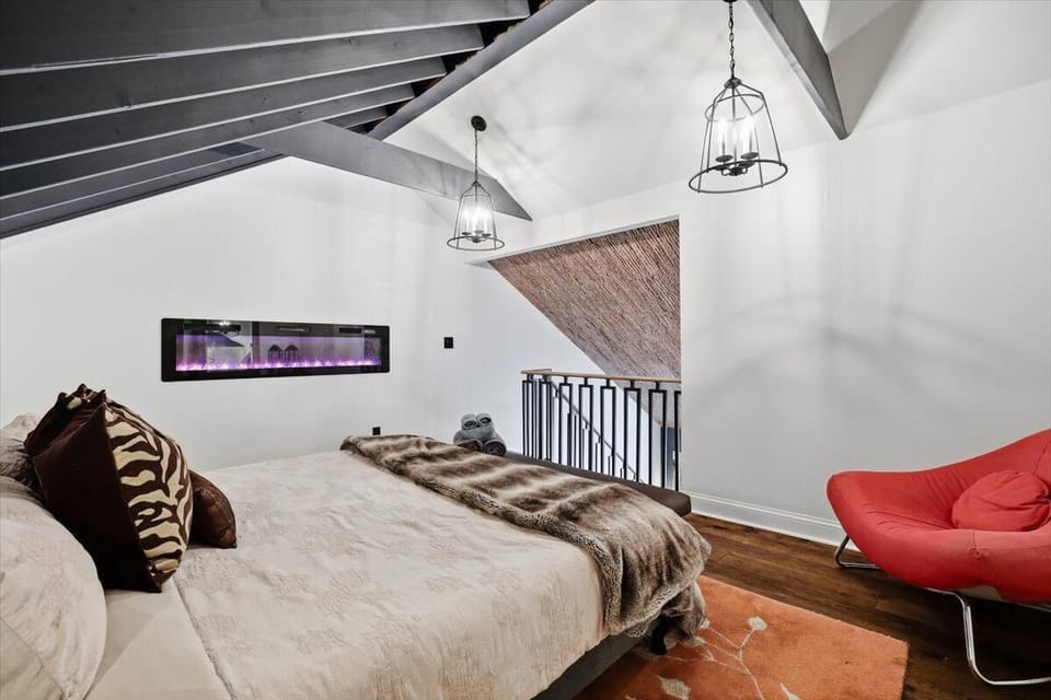 Wake up under the beams in the open loft king — the fireplace sits at the foot of the bed and the whole house is quiet below you.