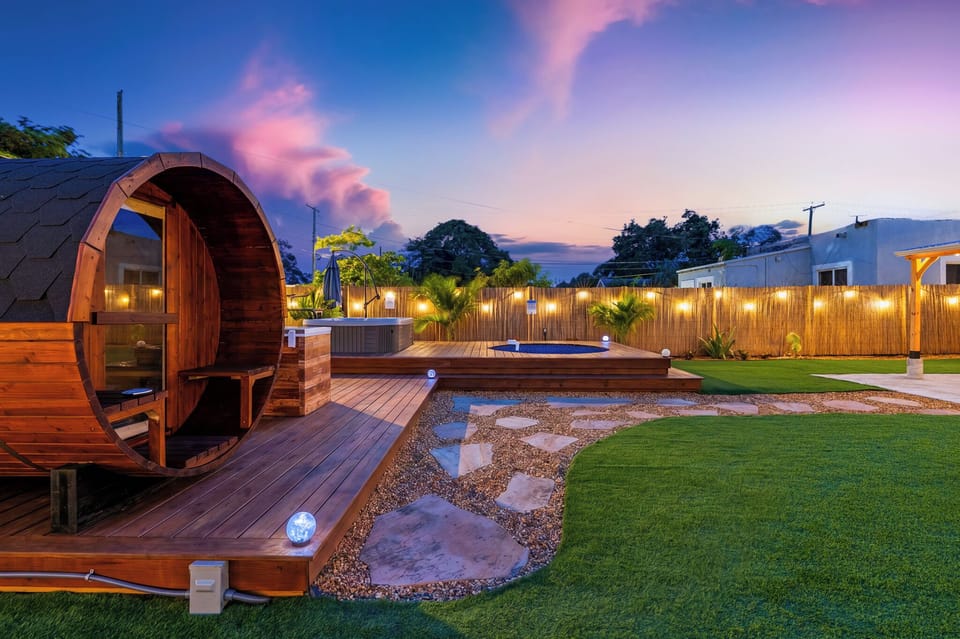 Beautiful outdoor wellness area featuring the sauna, landscaped yard, and wooden