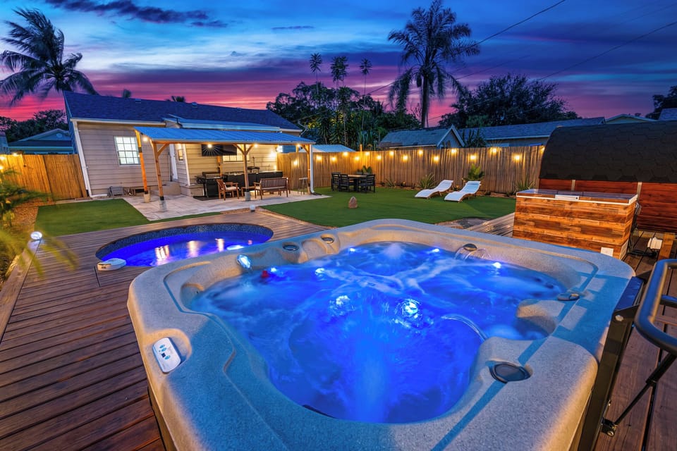 Luxury backyard oasis featuring a spa, cold plunge pool, sauna, BBQ, and ambient