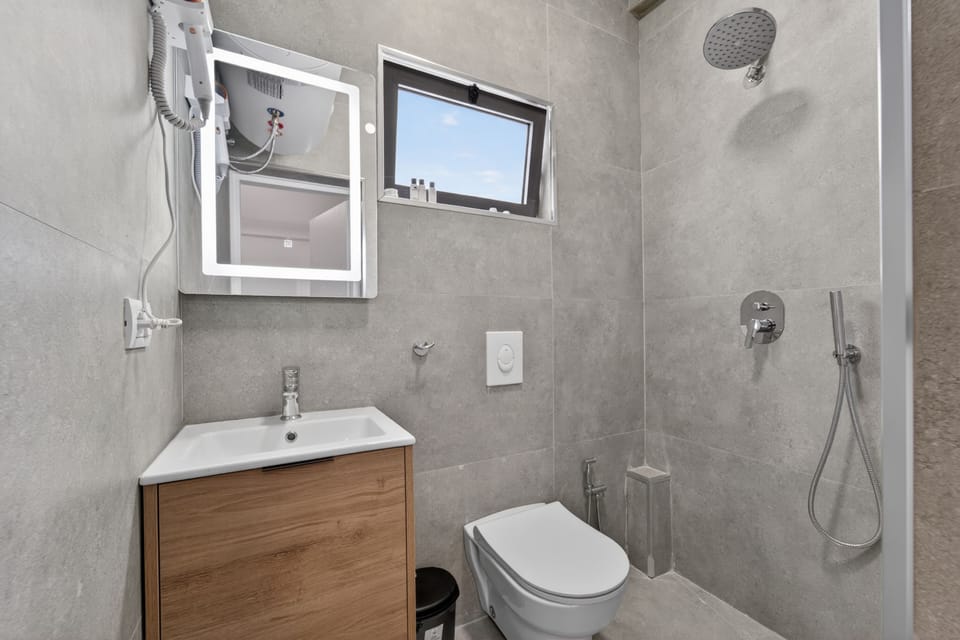 Shower, hair dryer, slippers, towels
