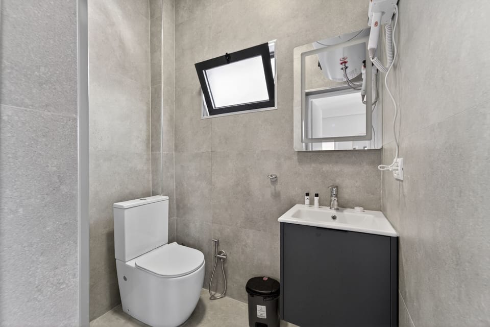 Shower, hair dryer, slippers, towels