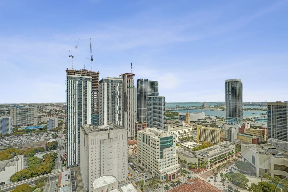 Breathtaking high-rise views overlooking the dynamic city skyline and the water in the distance