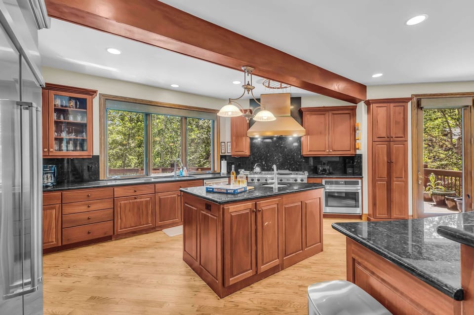 Kitchen: Fully equipped kitchen with a KitchenAid refrigerator, Viking Range stovetop, and breakfast bar