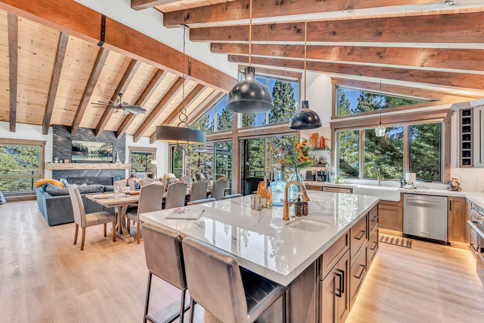Kitchen area featuring stainless steel appliances and an island with seating for 6.